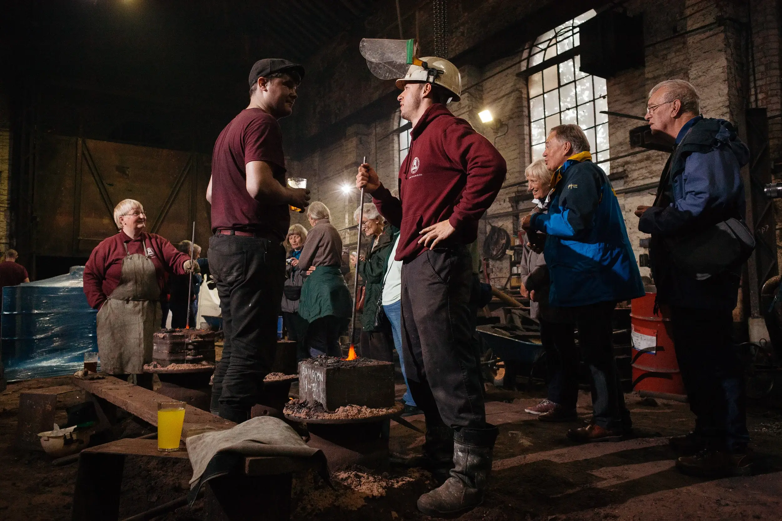 John Tayor & Co. Bell Foundry. The craftsmen ensure the metal fills the cast evenly by stirring the molten metal